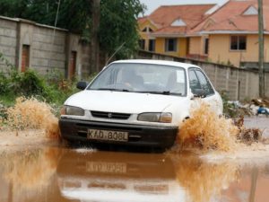 A motorist drives through the flooded Fairways Road in South C, Nairobi, on April 5. Nairobi residents grappled with fl ooded streets and blocked roads as heavy rains pounded the city and its environs for more than three months, following a long dry period /JACK OWUOR 